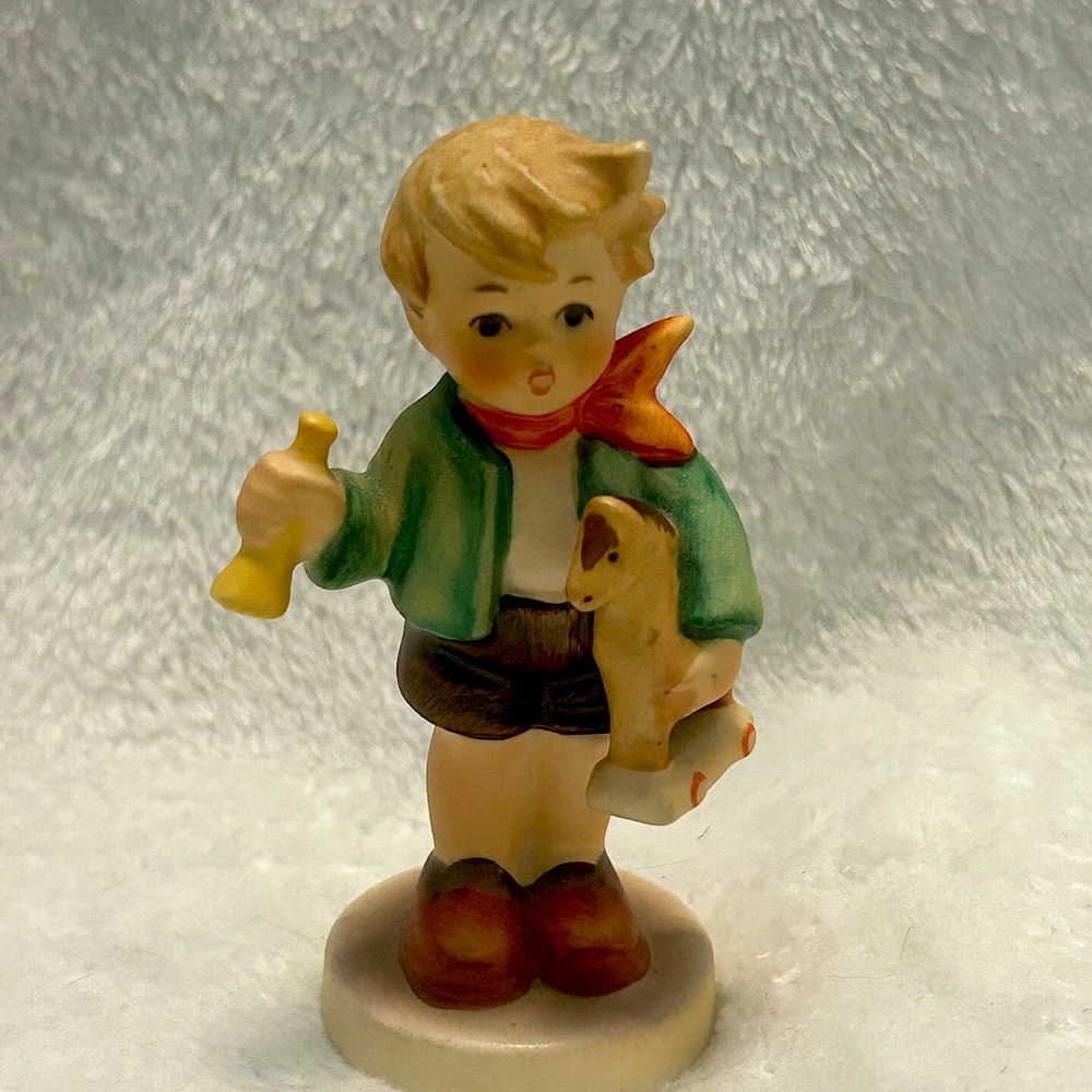 Goebel Germany porcelain figurine of boy holding horse.